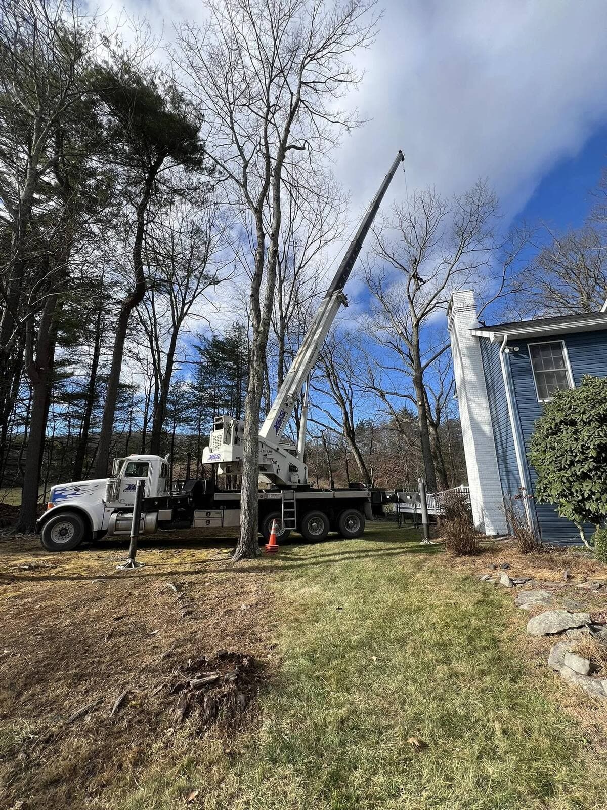 Gouger's Tree Care bucket truck and crane on a commercial job
